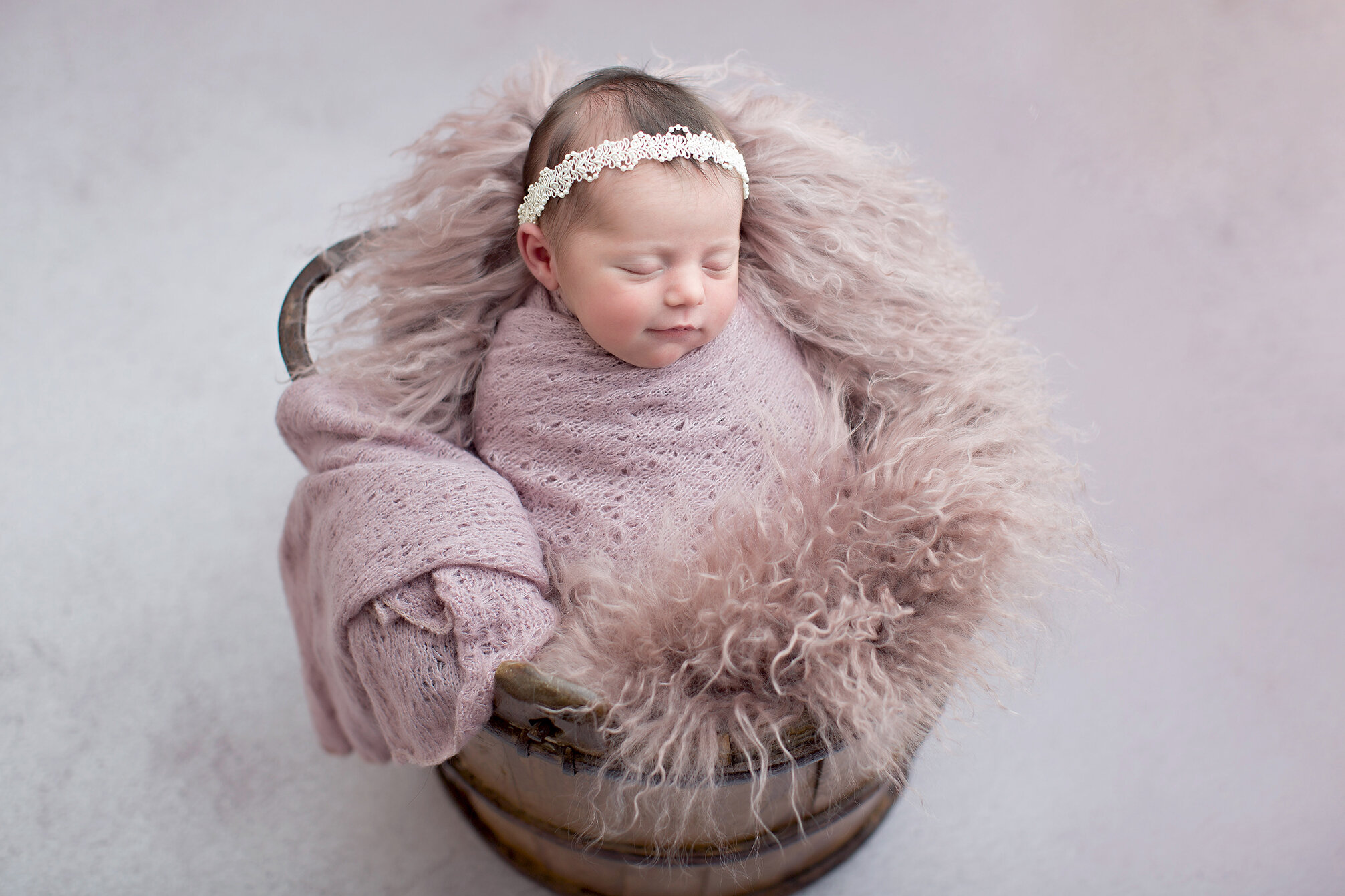 newborn photograph in bucket