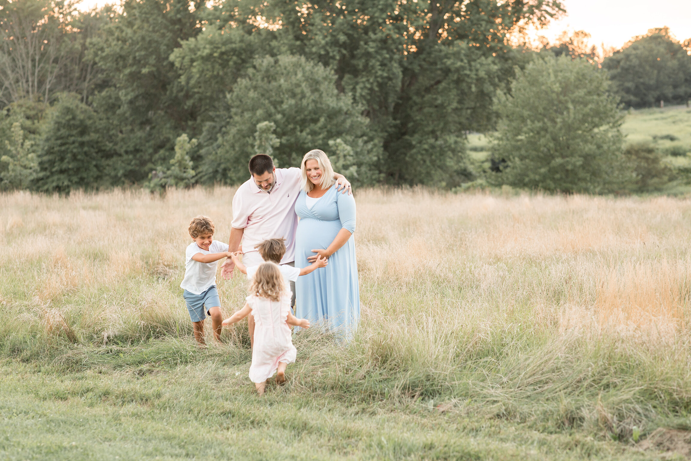 family playing in field newtown pa maternity photographer