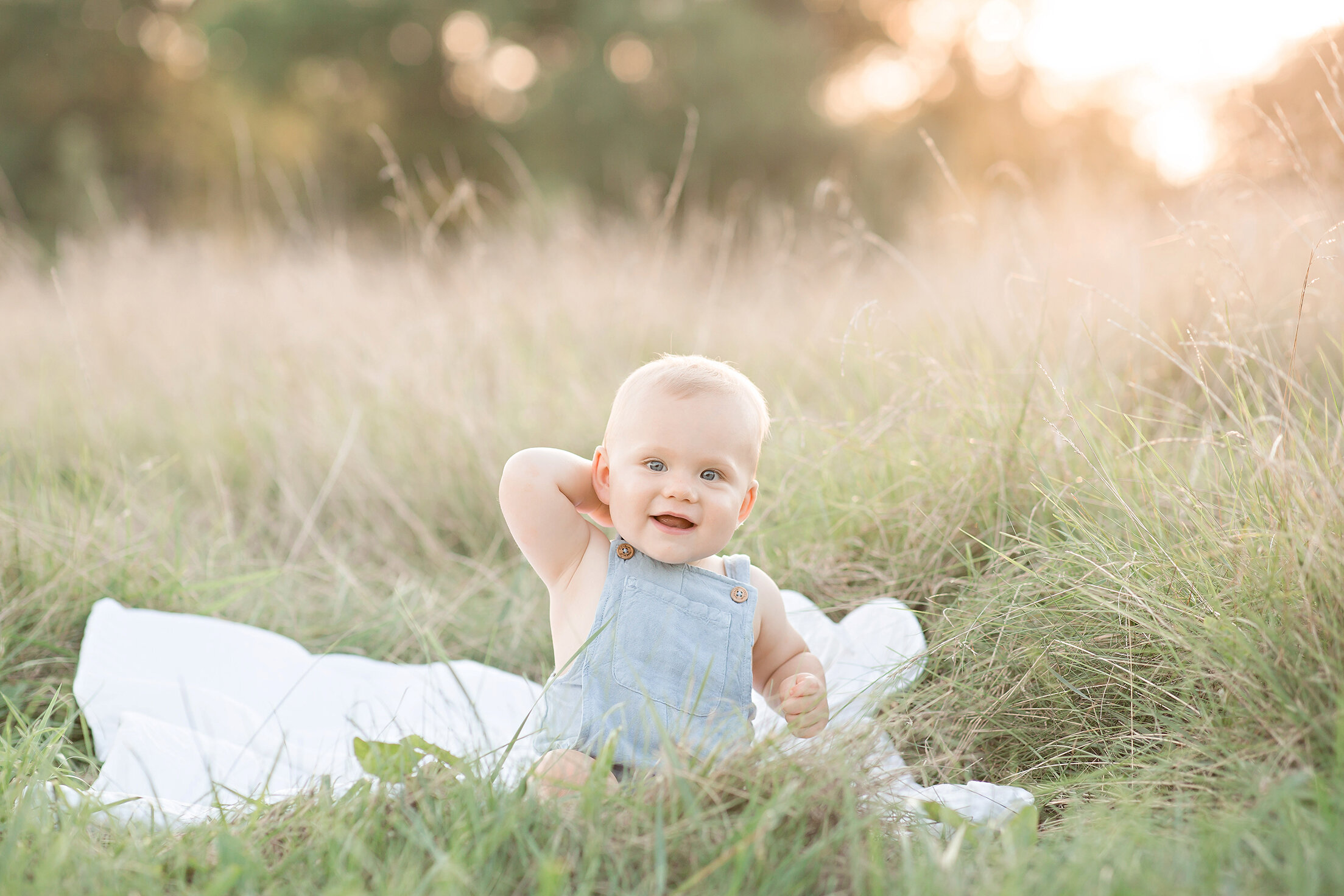 philadelphia newborn photographer baby sitting in grass