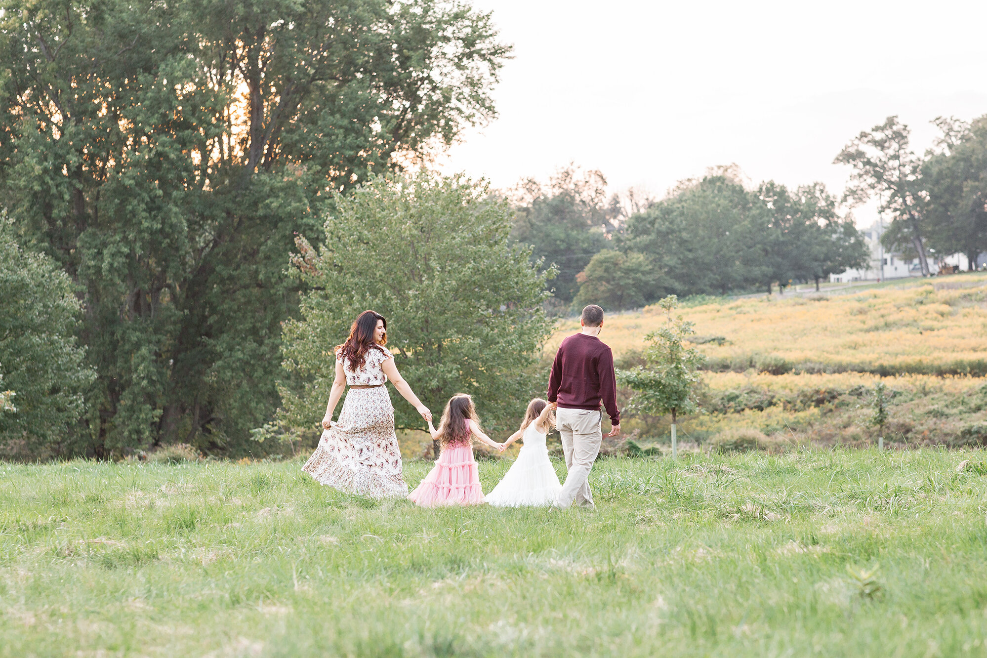 family walking in field philadelphia family photographer