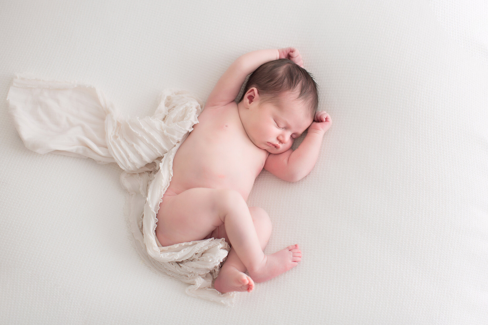 newborn simplicity laying on blanket