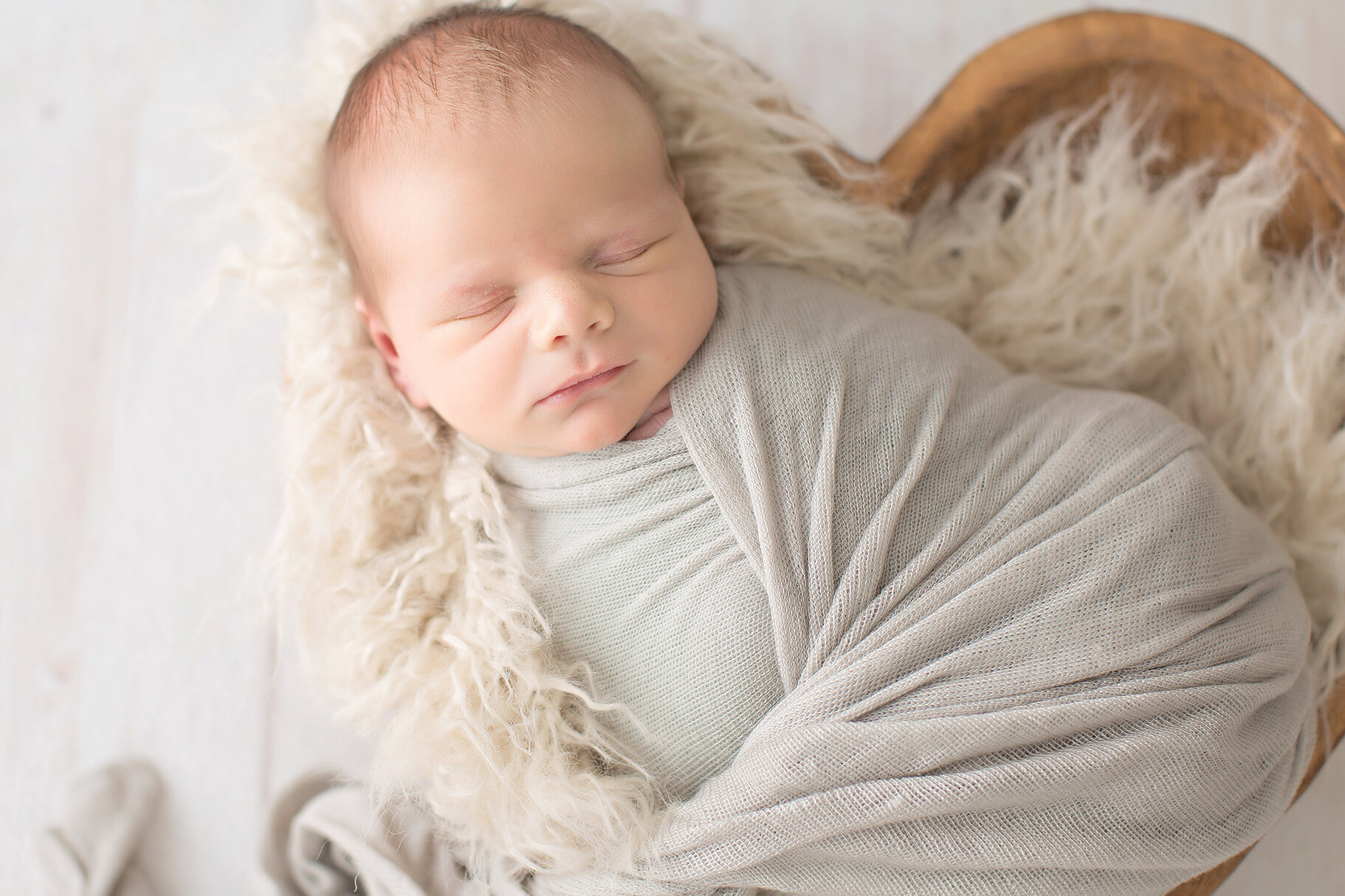 newborn boy in heart shaped bowl philadelphia photographer