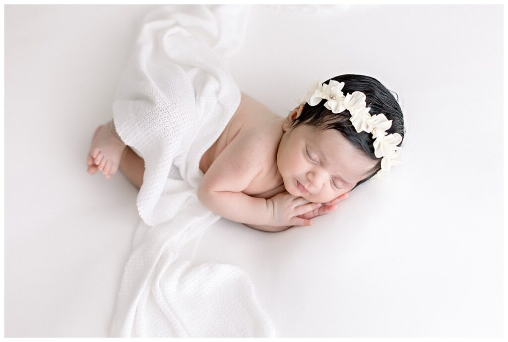 newborn photos baby girl laying with blanket