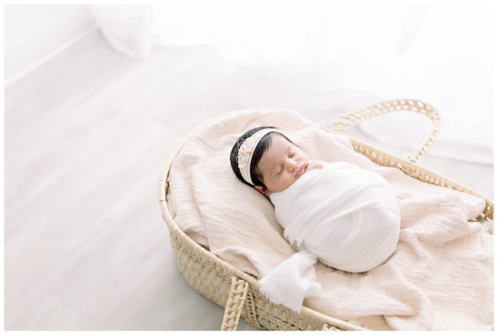 baby girl in moses basket