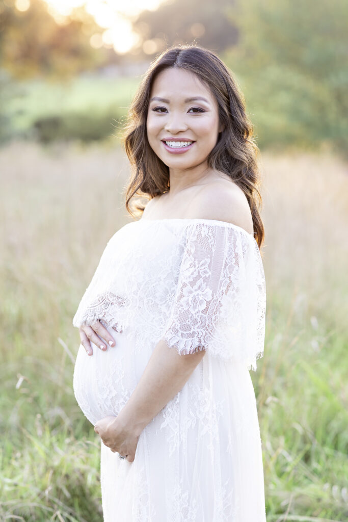 pregnant mom smiling for maternity pictures
