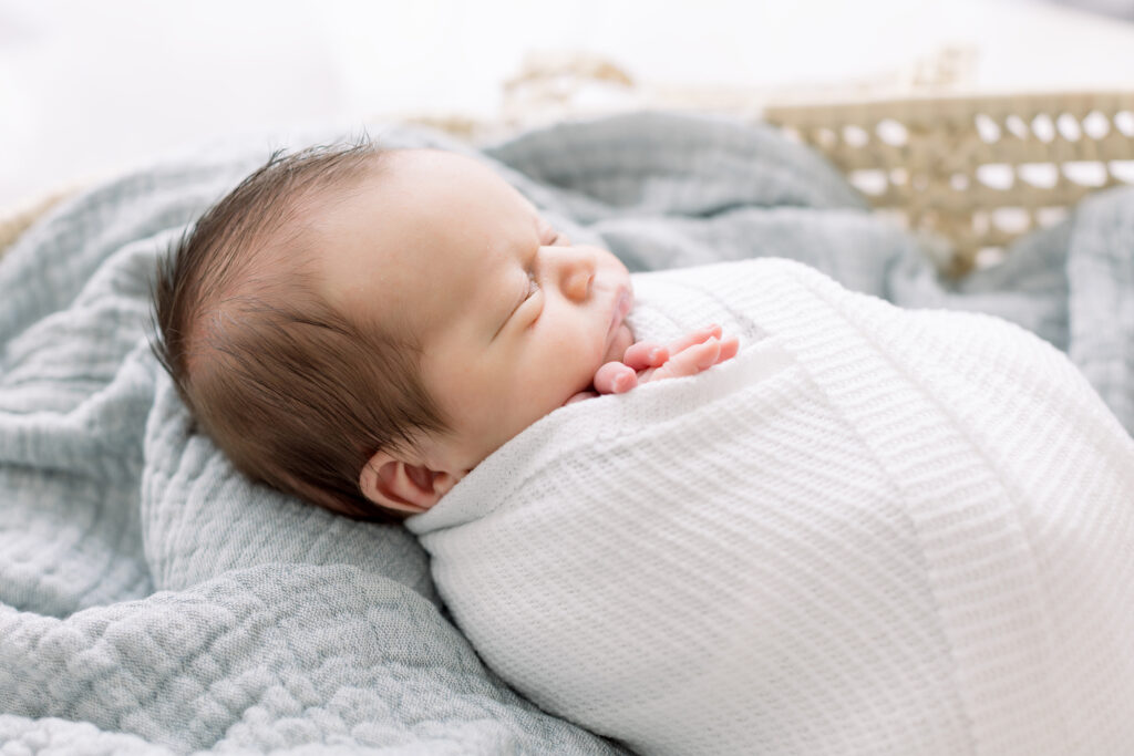 baby boy in moses basket blue blanket newborn photograph