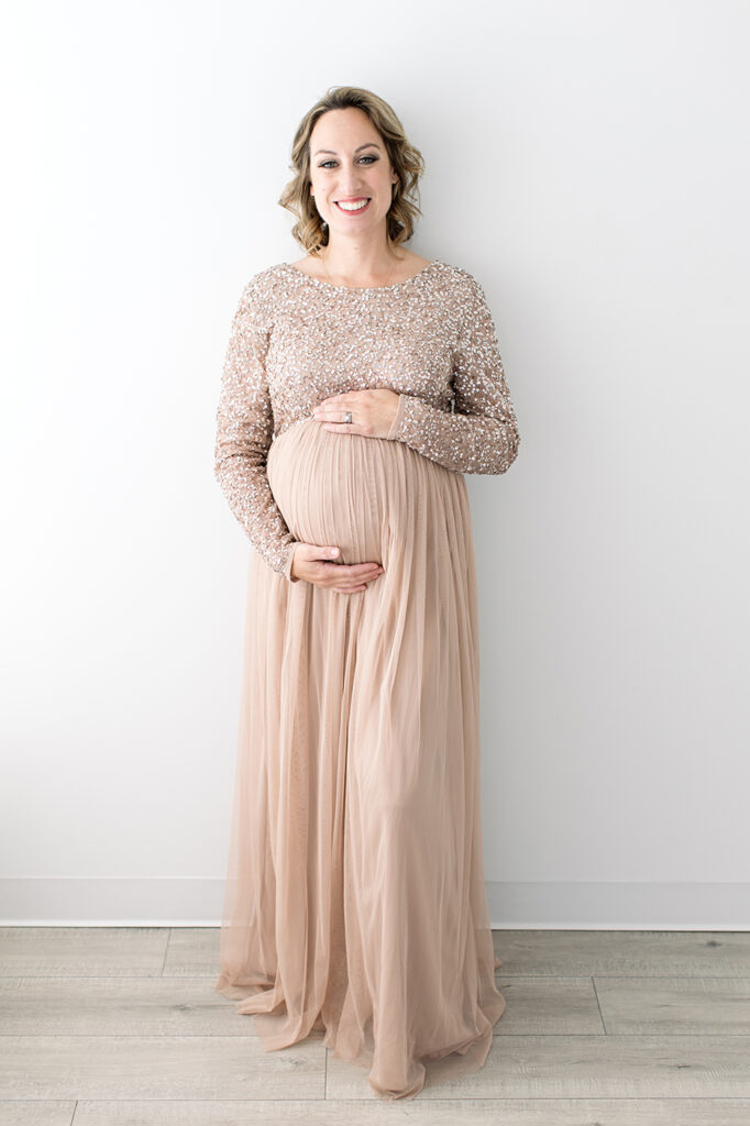 pregnant mom holding belly pink dress maternity pictures