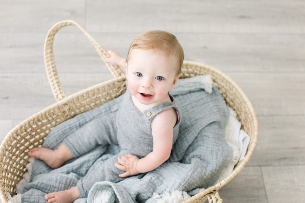baby boy smiling in basket