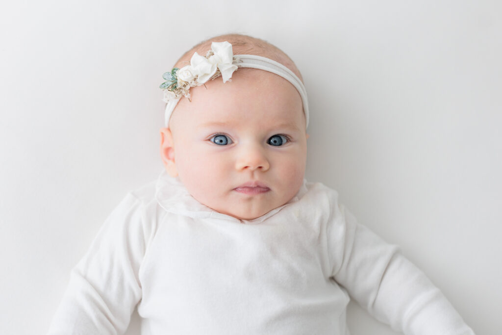 baby white onesite portrait blue eyes