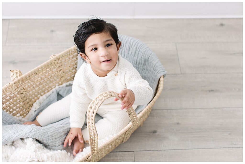 one year old in moses basket 