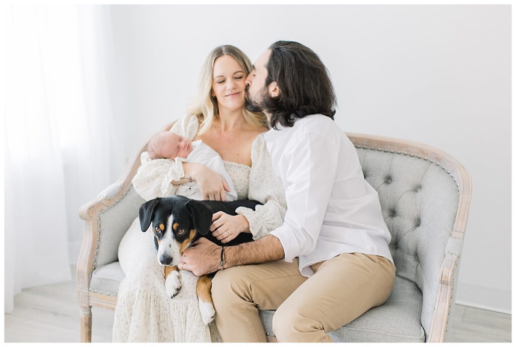 newborn family photo with dog on couch
