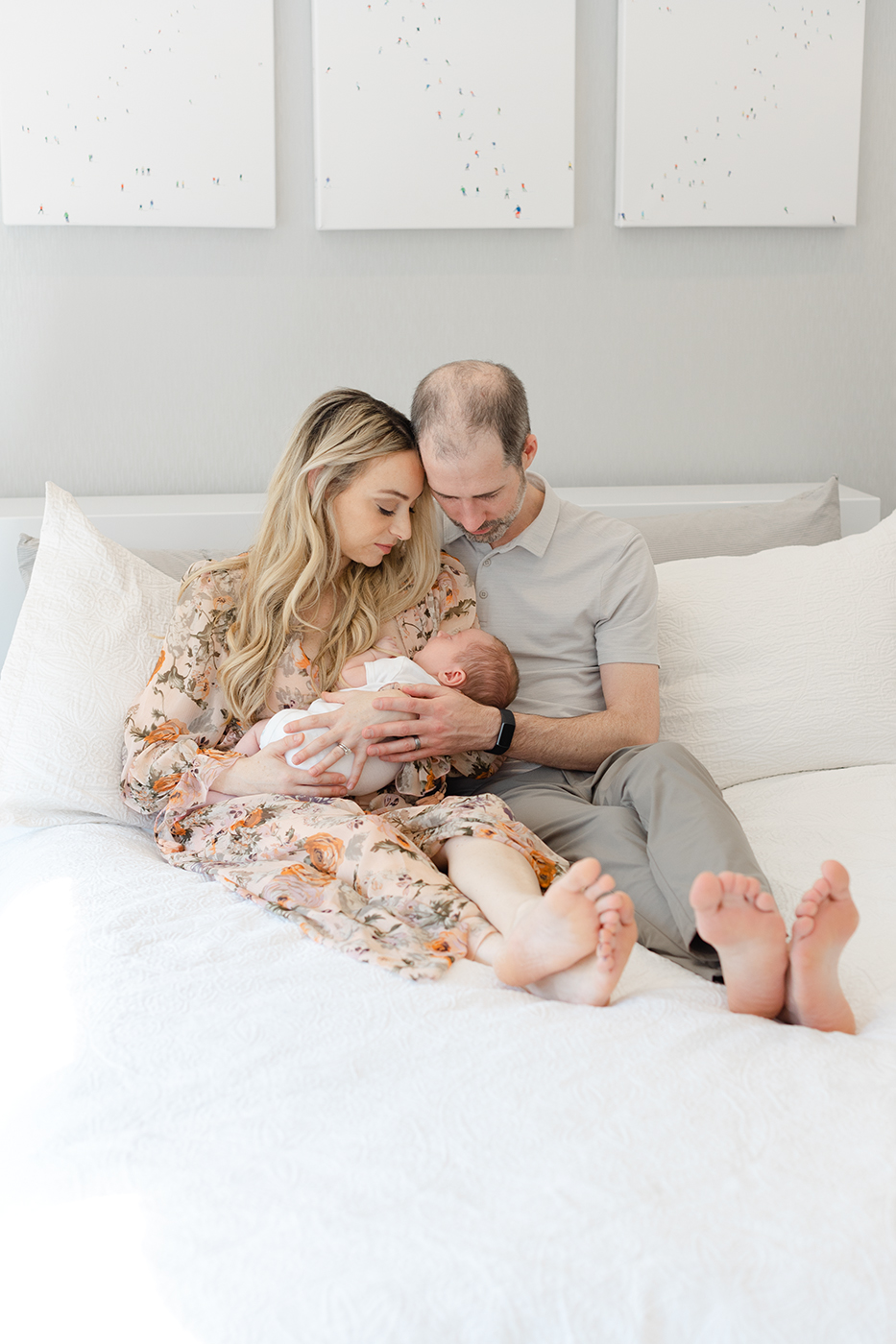 mom and dad hold at baby boy mainline lifestyle newborn photographer
