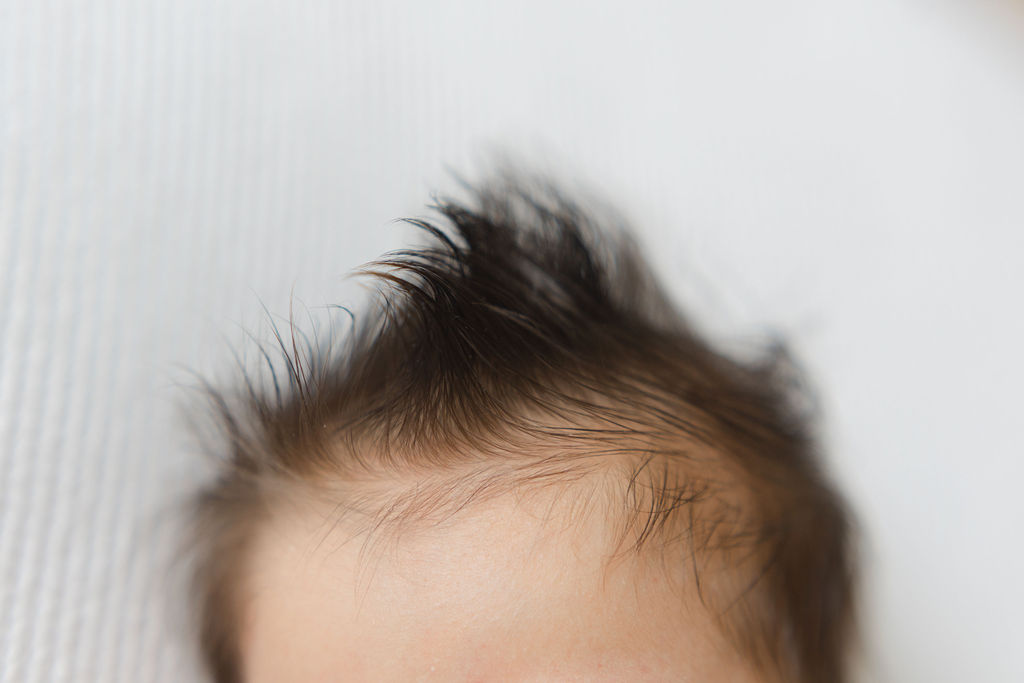 Details of a newborn baby head full of hair