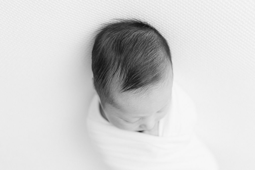 Details of a sleeping newborn baby's head with hair