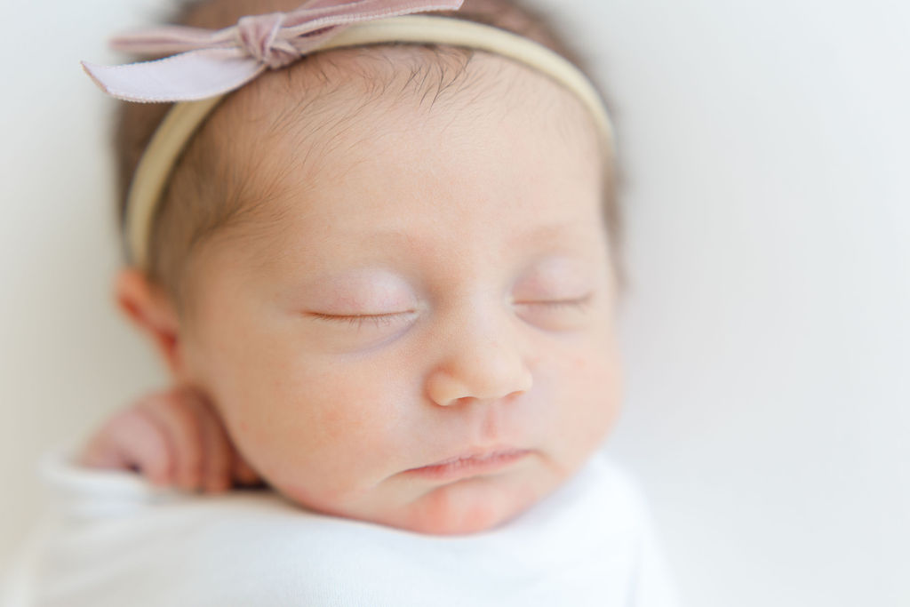 Details of a sleeping newborn baby girl's face