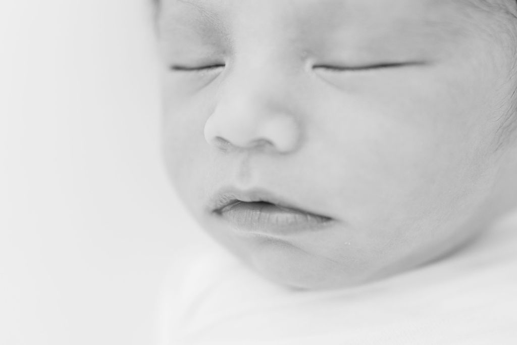 Details of a newborn baby's face in black and white