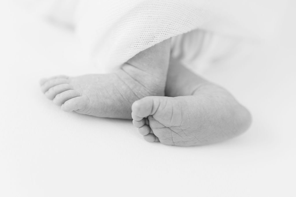 Details of a newborn baby's feet in black and white before visiting toy stores main line pa