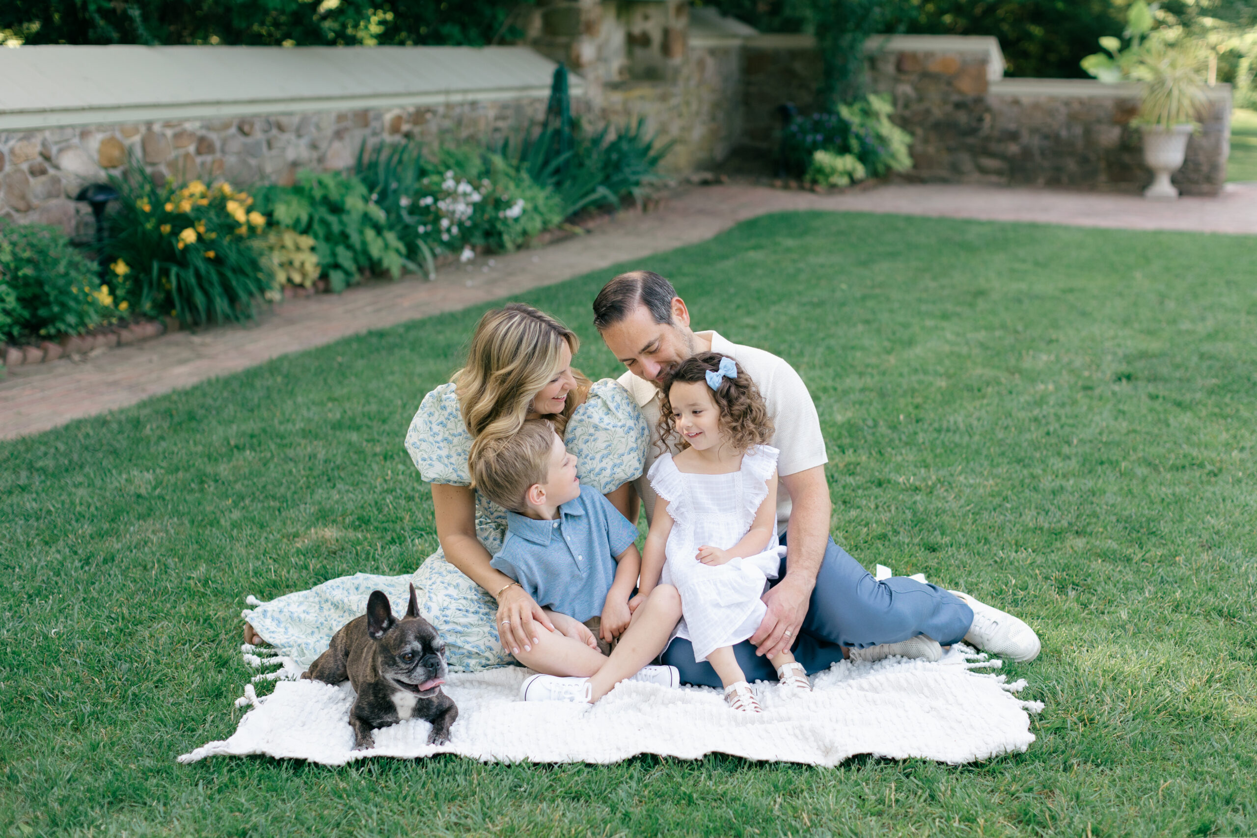 family walking together with stone building in backdrop