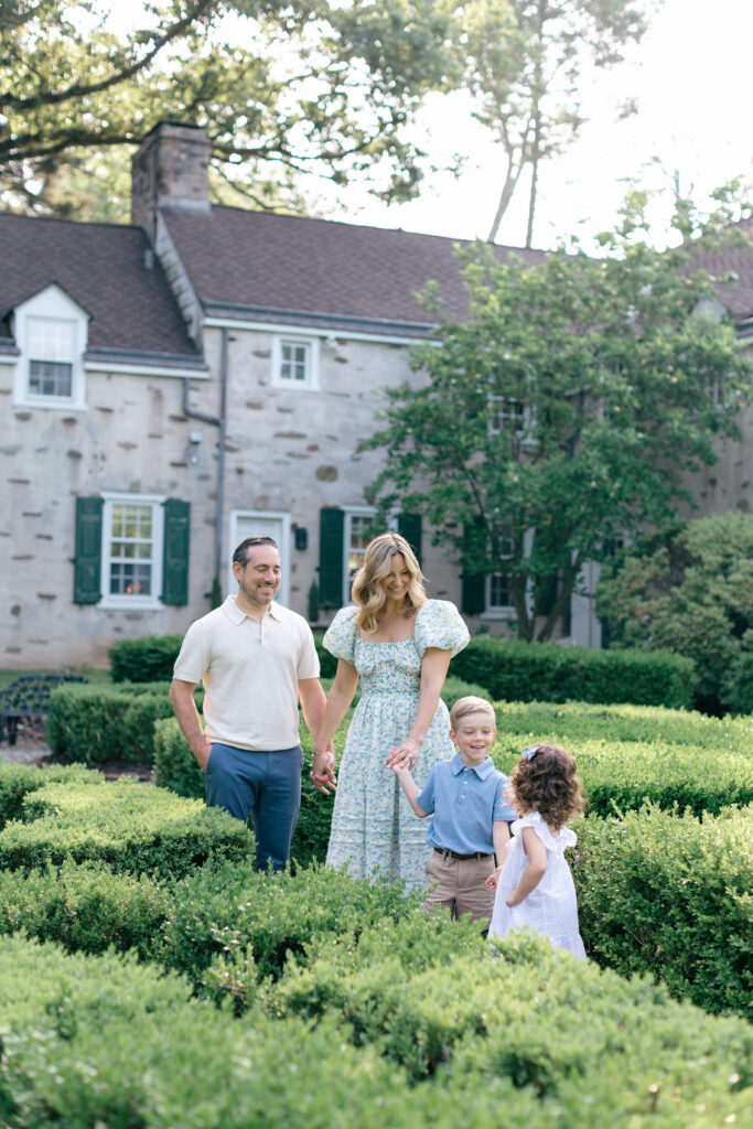 family walking together with stone building in backdrop