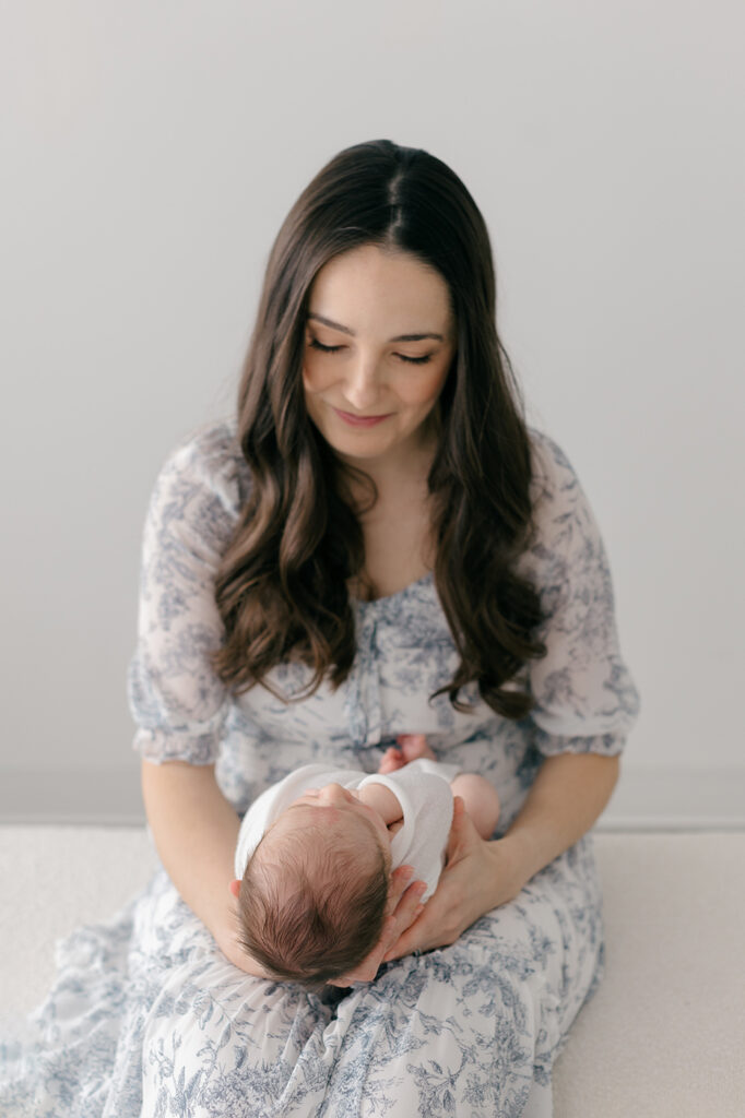 mom cuddling newborn baby during lifestyle photography session